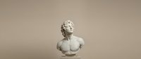 Neoclassical white marble bust sculpture of young male figure with curled hair against neutral beige background, suitable for art, history, and interior design projects.