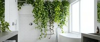 Modern bathroom interior with lush green hanging plants creating natural spa atmosphere. White subway tiles, freestanding bathtub, large window with natural light.