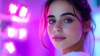 Young woman with natural makeup in neon pink lighting looking at camera with confident expression. Modern beauty portrait with glowing skin and soft focus effect.