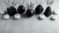 Modern autumn arrangement with white pumpkins and wheat stalks in black geometric vases on neutral background for seasonal home decor and styling.