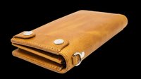 Tan leather bifold wallet with silver hardware, isolated on transparent background, ready for stickers, print on demand, T-shirt design, and clipart use.