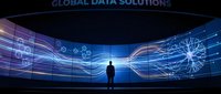 Business professional silhouette standing before curved digital display showing global data network connections and analytics visualization for technology presentations.