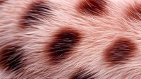Soft pink animal fur texture with dark spots creating natural pattern. Close-up macro photography reveals delicate hair strands and organic markings in rosy tones.