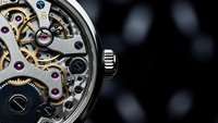Luxury mechanical watch with exposed movement showing intricate gears and jewels against dark background for premium timepiece advertising.
