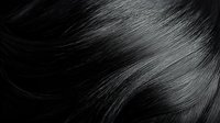 Silky smooth black hair texture in macro shot showing glossy strands with natural shine and movement against dark background. Suitable for beauty and haircare advertising.