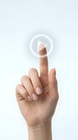 Female hand with manicured nails pressing transparent play button icon on white background for digital media and streaming interface design.