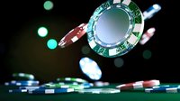Floating casino chips with dramatic lighting and bokeh effects against dark background, capturing motion and excitement of gambling entertainment.