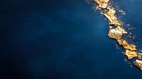 Luxurious gold leaf fragments scattered on deep navy blue textured background creating elegant abstract composition for luxury branding and design projects.