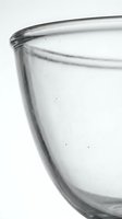 Clear glass bowl close-up on white background, transparent kitchen utensil with smooth curved edges, minimalist style for food and cooking concepts.
