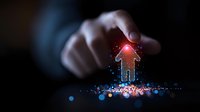 Glowing red arrow rises from magical sparkles and blue bokeh lights while hand reaches towards it, representing business growth and digital transformation concept.