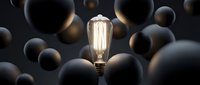 Vintage incandescent light bulb glowing brightly among dark spheres, symbolizing innovation, creativity, and standing out from the crowd for business concepts.