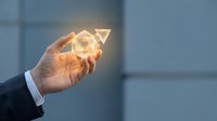 Businessman hand holding glowing upward arrow symbol representing growth, success, and financial progress in modern corporate environment.