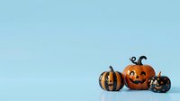Smiling jack-o-lantern pumpkin with striped and black decorative pumpkins on light blue background, isolated for Halloween designs and seasonal marketing materials.