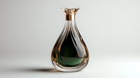 Elegant glass decanter with dark green liquid and gold-toned stopper on neutral background, showcasing luxury beverage or fragrance packaging design.