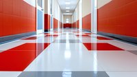 Empty modern school corridor with red and white checkered floor pattern and bright red walls leading to illuminated hallway with fluorescent lighting.
