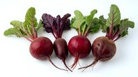Fresh organic beetroot with green leaves isolated on white background for healthy cooking and nutrition concepts.