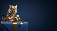 Tiger cub sitting on blue gift box with gold ribbon against dark blue background, luxury present concept for holidays and celebrations.
