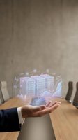 Businessman holding a glowing holographic server rack with data charts and network icons above his palm in a modern office.