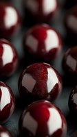 Fresh ripe cherries with water drops on dark background, macro shot showing glossy surface and natural reflection. Suitable for food packaging design.