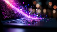 Magical glowing particles stream in pink and purple colors against dark background with bokeh lights creating dreamy atmospheric effect. Suitable for fantasy designs.