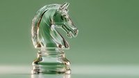 Elegant glass chess knight piece with translucent green background, showcasing strategic game element for business concept and board game design.