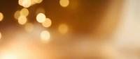 Warm golden bokeh lights create an elegant, blurred background perfect for overlays, presentations, and festive design projects.