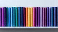 Colorful book spines arranged in rainbow spectrum order on white shelf, creating minimalist gradient pattern from purple through blue, yellow and back to purple.