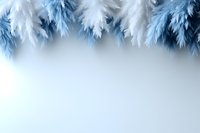 Soft white and blue feathers creating dreamy border frame on light background, gentle ethereal mood for wedding, celebration or spiritual design elements.