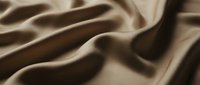 Smooth beige fabric with soft folds and drapes, showcasing luxurious textile texture and material quality for design and fashion projects.