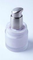 Frosted glass cosmetic bottle with metallic silver pump dispenser isolated on white background, suitable for skincare, serum, and beauty product packaging design.