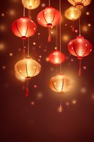 Glowing red and gold Chinese paper lanterns with tassels hanging against dark background with bokeh lights, creating festive oriental atmosphere.