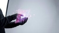 Businessman hand holding glowing digital 5G network hologram with wireless connectivity symbols and data transmission effects on gray background.