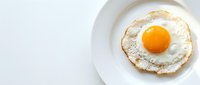 Fried egg with golden yolk on white plate, crispy edges and runny center for breakfast menu, cooking blog, healthy morning meal concept.