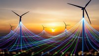 Futuristic wind turbines with colorful energy streams at sunset showcasing renewable power generation and sustainable technology innovation.