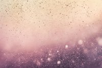 Dreamy pink and purple abstract background with glowing particles and bokeh effects creates magical atmosphere for festive designs and celebrations.