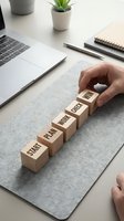 Business planning concept with wooden blocks spelling start plan work dream win on office desk with laptop and hands arranging strategy steps.