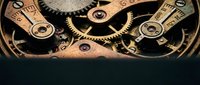 Vintage mechanical clockwork gears and springs in warm golden tones showcasing intricate craftsmanship and precision engineering details.