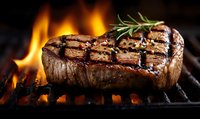 Juicy grilled beef steak with rosemary on flaming barbecue grill, showcasing perfect char marks and sizzling flames for food photography.