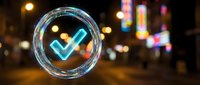 Glowing neon checkmark symbol inside transparent bubble floating over blurred city lights at night. Digital verification and approval concept for business.