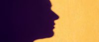 Silhouette of a person's profile against a warm yellow background, suitable for psychology, mental health, wellness, and corporate branding projects.