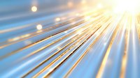 Diagonal golden light rays burst through soft blue atmosphere creating dramatic sunbeam effect with lens flare and glowing particles. Suitable for spiritual backgrounds.