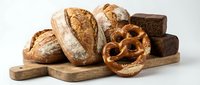 Assorted fresh baked bread loaves and pretzel on wooden board, isolated on white background for bakery, food and culinary design projects.