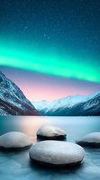 Magical aurora borealis over snow-capped mountains and frozen lake with round stones in foreground, creating serene winter landscape in pink and turquoise colors.