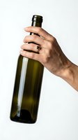 Male hand holding dark green glass wine bottle against white background, isolated for beverage and alcohol advertising use.
