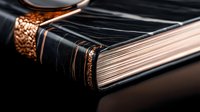 Elegant leather-bound book with ornate copper detailing and aged pages, classic literature concept for education, reading, and vintage publishing designs.