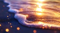 Gentle ocean wave rolling onto sandy beach at golden sunset with sparkling water droplets and bokeh light effects creating dreamy atmospheric seascape.