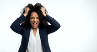 Frustrated African American businesswoman pulling hair in stress and anger, screaming with eyes closed, isolated on white background for design use.