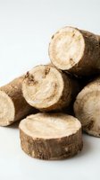 Freshly cut wooden logs stacked with exposed circular cross-sections showing growth rings, suitable for forestry, lumber, and timber industry applications.