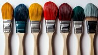 Colorful art brushes arranged in row on white background showing yellow, blue, red and green bristles. Professional painting tools isolated for creative design.