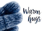 Cozy winter composition with warm blue knitted wool mittens and handwritten calligraphy text on white background for seasonal greeting cards and social media.